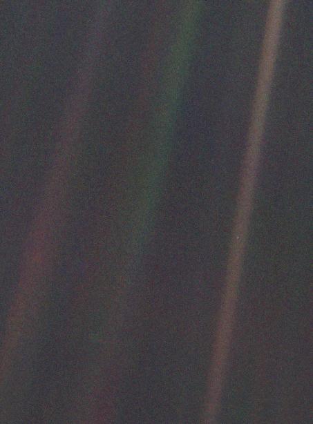 Original caption written by Nasa: This narrow-angle color image of the Earth, dubbed 'Pale Blue Dot', is a part of the first ever 'portrait' of the solar system taken by Voyager 1. The spacecraft acquired a total of 60 frames for a mosaic of the solar system from a distance of more than 4 billion miles from Earth and about 32 degrees above the ecliptic. From Voyager's great distance Earth is a mere point of light, less than the size of a picture element even in the narrow-angle camera. Earth was a crescent only 0.12 pixel in size. Coincidentally, Earth lies right in the center of one of the scattered light rays resulting from taking the image so close to the sun. This blown-up image of the Earth was taken through three color filters -- violet, blue and green -- and recombined to produce the color image. The background features in the image are artifacts resulting from the magnification.